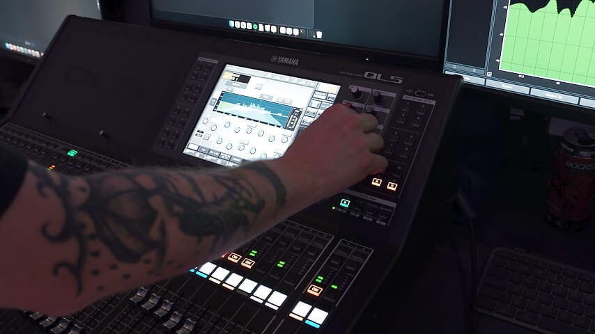 Engineer mixing on a Yamaha console at front of house