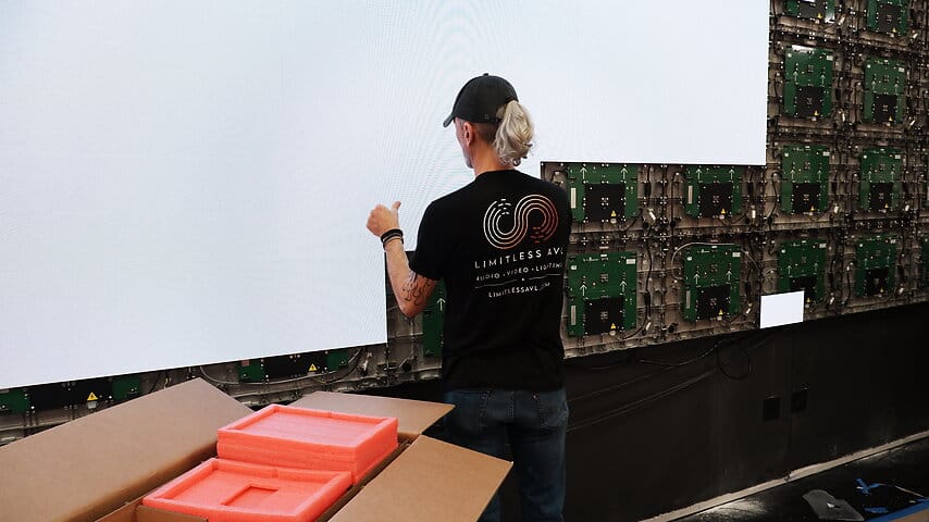Limitless AVL technician installing a church LED video wall